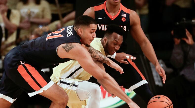Virginia forward Isaiah Wilkins (21) and Georgia Tech guard Josh Okogie (5) battle for a loose ball during the first half of an NCAA college basketball game Thursday, Jan. 18, 2018, in Atlanta. (AP Photo/John Bazemore)