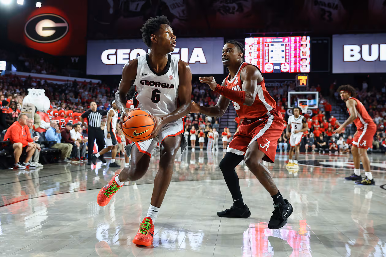 Georgia forward Kanon Catchings (6) looks to pass against Alabama guard Latrell Wrightsell Jr., right, during the second half of an NCAA college basketball game, Tuesday, March 3, 2026, in Athens, Ga. (AP Photo/Colin Hubbard)