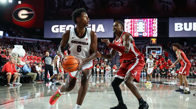 Georgia forward Kanon Catchings (6) looks to pass against Alabama guard Latrell Wrightsell Jr., right, during the second half of an NCAA college basketball game, Tuesday, March 3, 2026, in Athens, Ga. (AP Photo/Colin Hubbard)