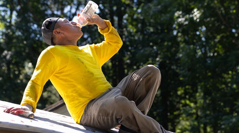 Francisco Rivera hydrates as metro Atlanta flirted with 100-degree temps last summer. New projections by the National Oceanic and Atmospheric Administration show summer is likely to be hotter and wetter than normal in much of the South this year. (AJC 2024)