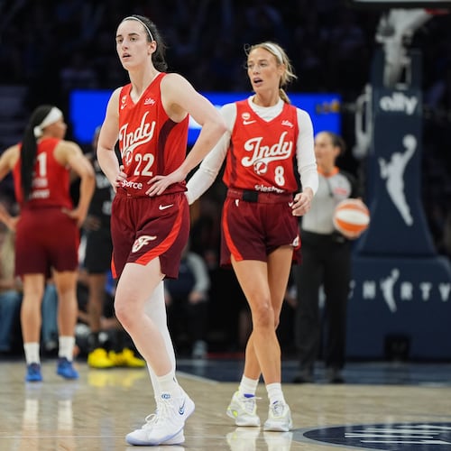 Indiana Fever guards Caitlin Clark (22) and Sophie Cunningham (8) wait for play to resume during the second half of a WNBA basketball game against the Minnesota Lynx, Sunday, Aug. 2, 2026, in Minneapolis. (AP Photo/Abbie Parr)