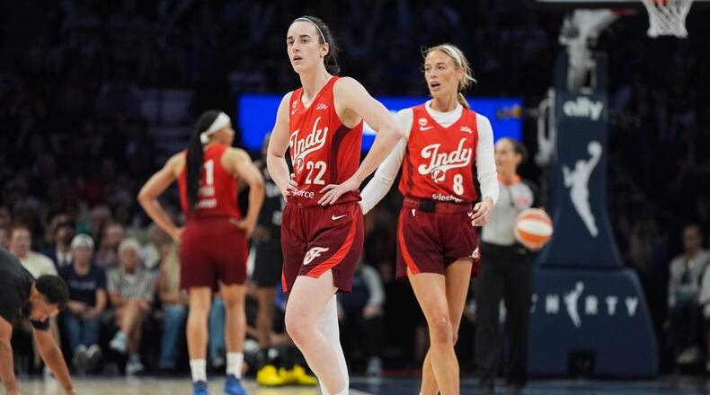 Indiana Fever guards Caitlin Clark (22) and Sophie Cunningham (8) wait for play to resume during the second half of a WNBA basketball game against the Minnesota Lynx, Sunday, Aug. 2, 2026, in Minneapolis. (AP Photo/Abbie Parr)