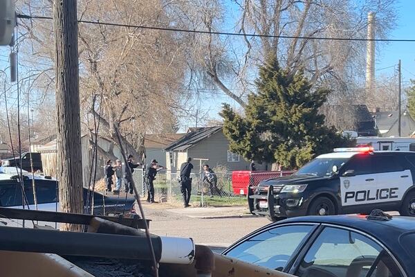 In this image taken from video, police are seen shortly before opening fire on a teen on the other other side of a fence Saturday, April 5, 2025, in Pocatello, Idaho. (Brad Andres via AP)