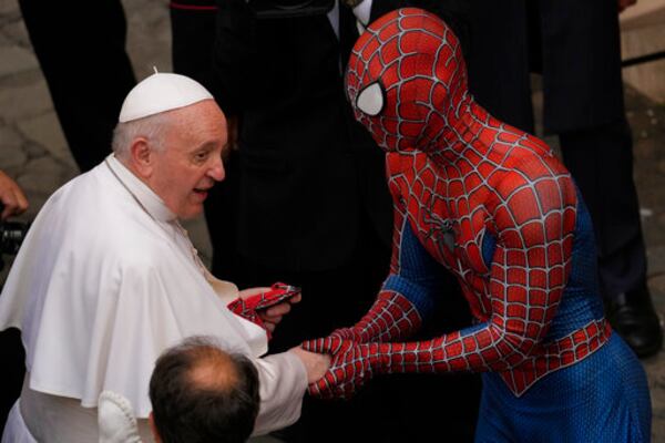 FILE - Pope Francis meets a man wearing a Spider-Man costume, who presented him with his mask, at the end of his weekly general audience with a limited number of faithful in the San Damaso Courtyard at the Vatican, Wednesday, June 23, 2021. (AP Photo/Andrew Medichini, file)