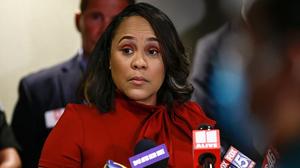 Surrounded by Fulton County law enforcement officials, District Attorney Fani Willis speaks during a news conference in 2022. Her subpoena fight will be heard by the Georgia Supreme Court. (Natrice Miller/AJC/TNS)