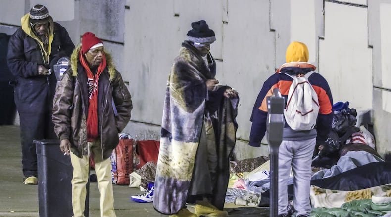 January 9, 2019 Atlanta: Leroy Thomas (third from left) says the Atlanta police told the people staying on Bell Street in Atlanta under the downtown connector sleeping overnight that they would all need to be cleared and out of the area because of the Super Bowl. The Southern Center for Human Rights has accused the city of seeking to sanitize the city’s image ahead of the Super Bowl by jailing the homeless. JOHN SPINK/JSPINK@AJC.COM