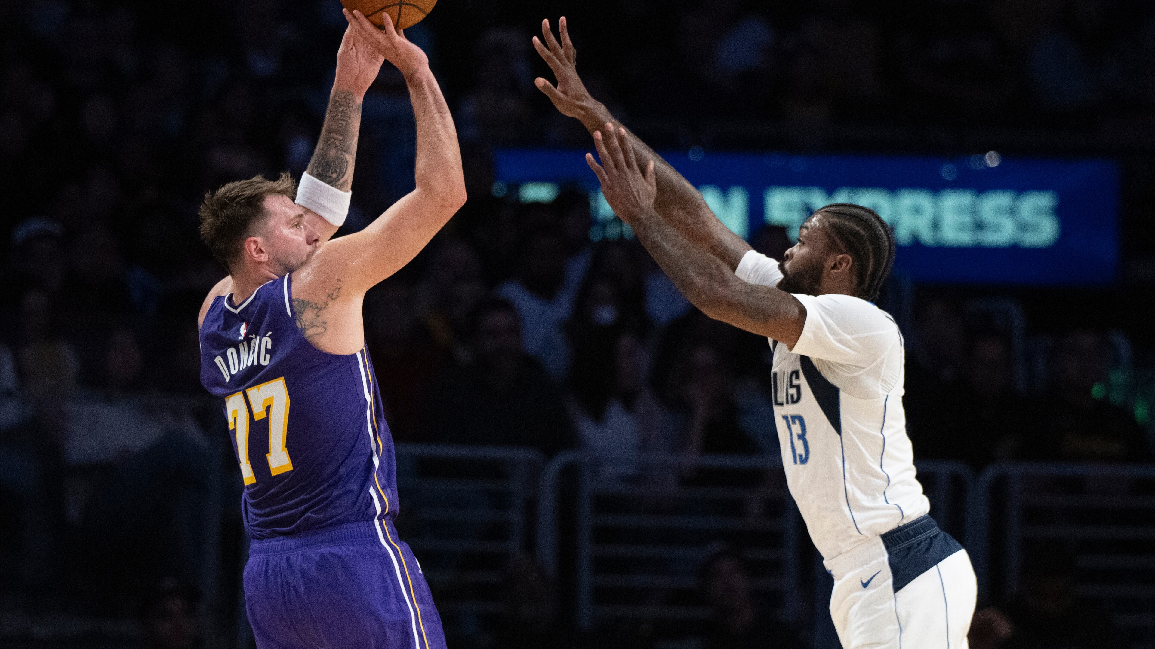 Los Angeles Lakers guard Luka Doncic (77) shoots as Dallas Mavericks forward Naji Marshall (13) defends during the first half of an NBA Cup basketball game in Los Angeles, Friday, Nov. 28, 2025. (AP Photo/Kyusung Gong)