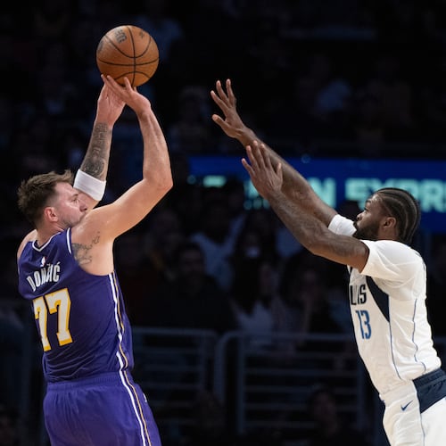 Los Angeles Lakers guard Luka Doncic (77) shoots as Dallas Mavericks forward Naji Marshall (13) defends during the first half of an NBA Cup basketball game in Los Angeles, Friday, Nov. 28, 2025. (AP Photo/Kyusung Gong)