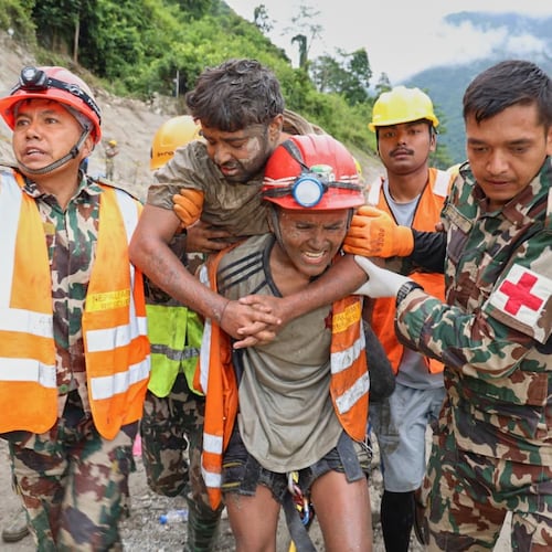 In this photo provided by the Nepal Army, soldiers rescue a worker alive from a tunnel during an ongoing operation at the Trishuli-3A hydropower project in Nepal's Rasuwa district, Friday, Sept. 4, 2026. (Nepal Army via AP)