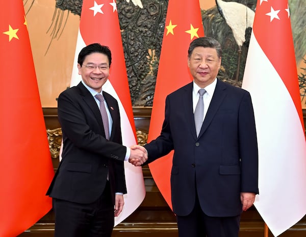 In this photo released by Xinhua News Agency, Chinese President Xi Jinping meets with Singaporean Prime Minister Lawrence Wong at the Great Hall of the People in Beijing on Tuesday, June 24, 2025. (Yue Yuewei/Xinhua via AP)