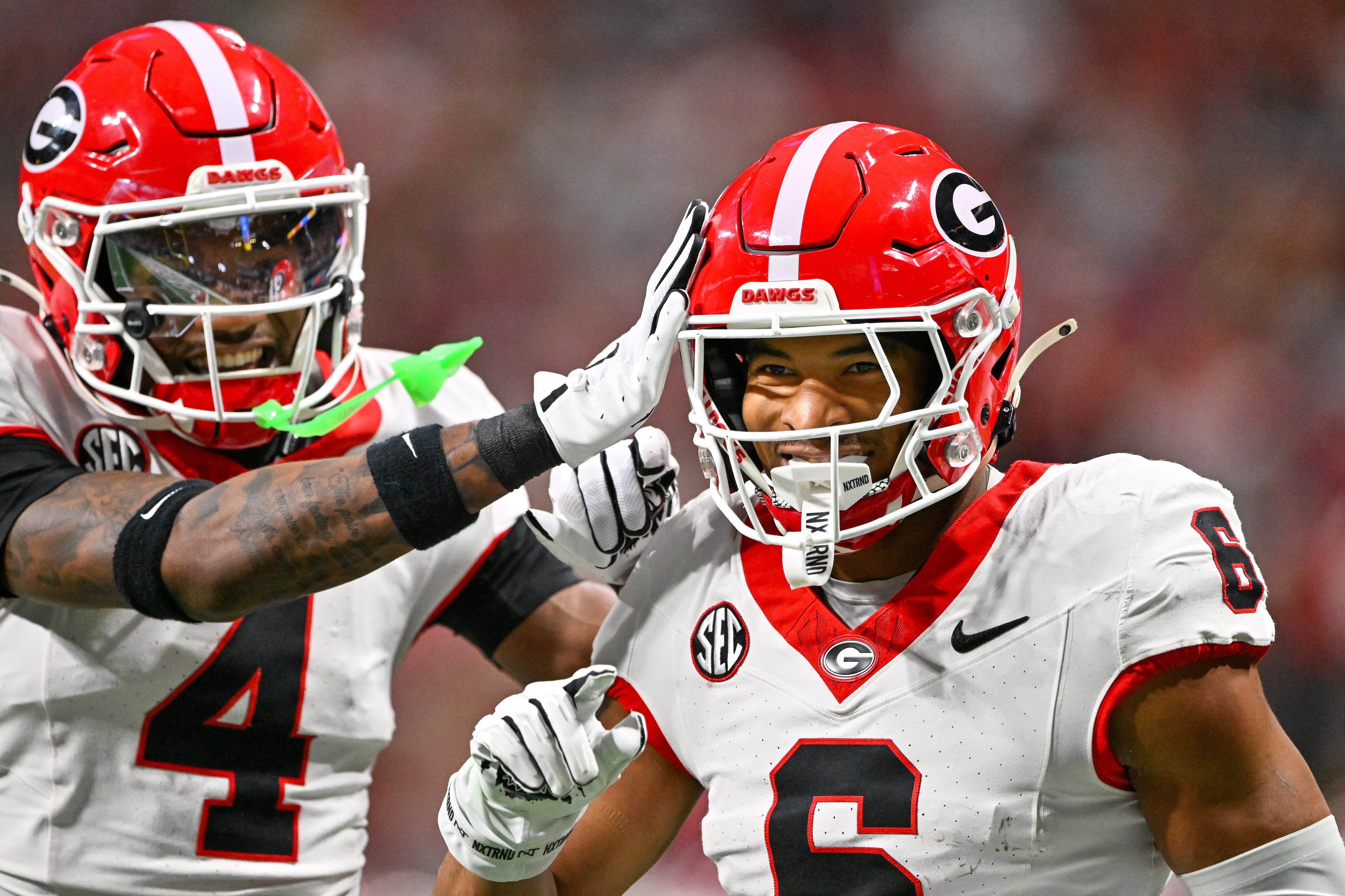 Georgia defensive back Daylen Everette (6)) celebrates with Kj Bolden (4) after intercepting a pass from Alabama quarterback Ty Simpson during the first half of the SEC Championship game at Mercedes-Benz Stadium, Saturday, Dec. 6, 2025, in Atlanta. (Hyosub Shin / AJC)