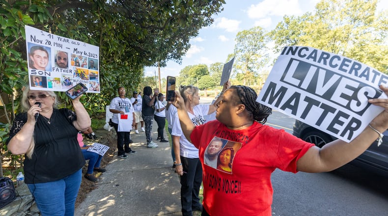 Carrie Proffitt (left) speaks about her son, Dennis, who died in prison as she and other advocates demonstrated across the street from the governor's mansion on Tuesday, Oct. 3, 2023, to protest prison conditions. (Steve Schaefer/steve.schaefer@ajc.com)