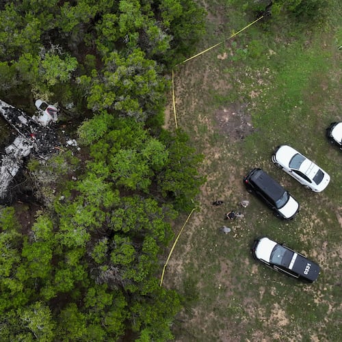 A crashed Cessna airplane is seen in a wooded area on Round Rock Road in Wimberley, Texas, Friday, May 1, 2026. (Jay Janner/Austin American-Statesman via AP)