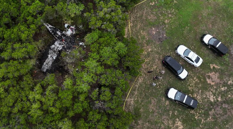 A crashed Cessna airplane is seen in a wooded area on Round Rock Road in Wimberley, Texas, Friday, May 1, 2026. (Jay Janner/Austin American-Statesman via AP)