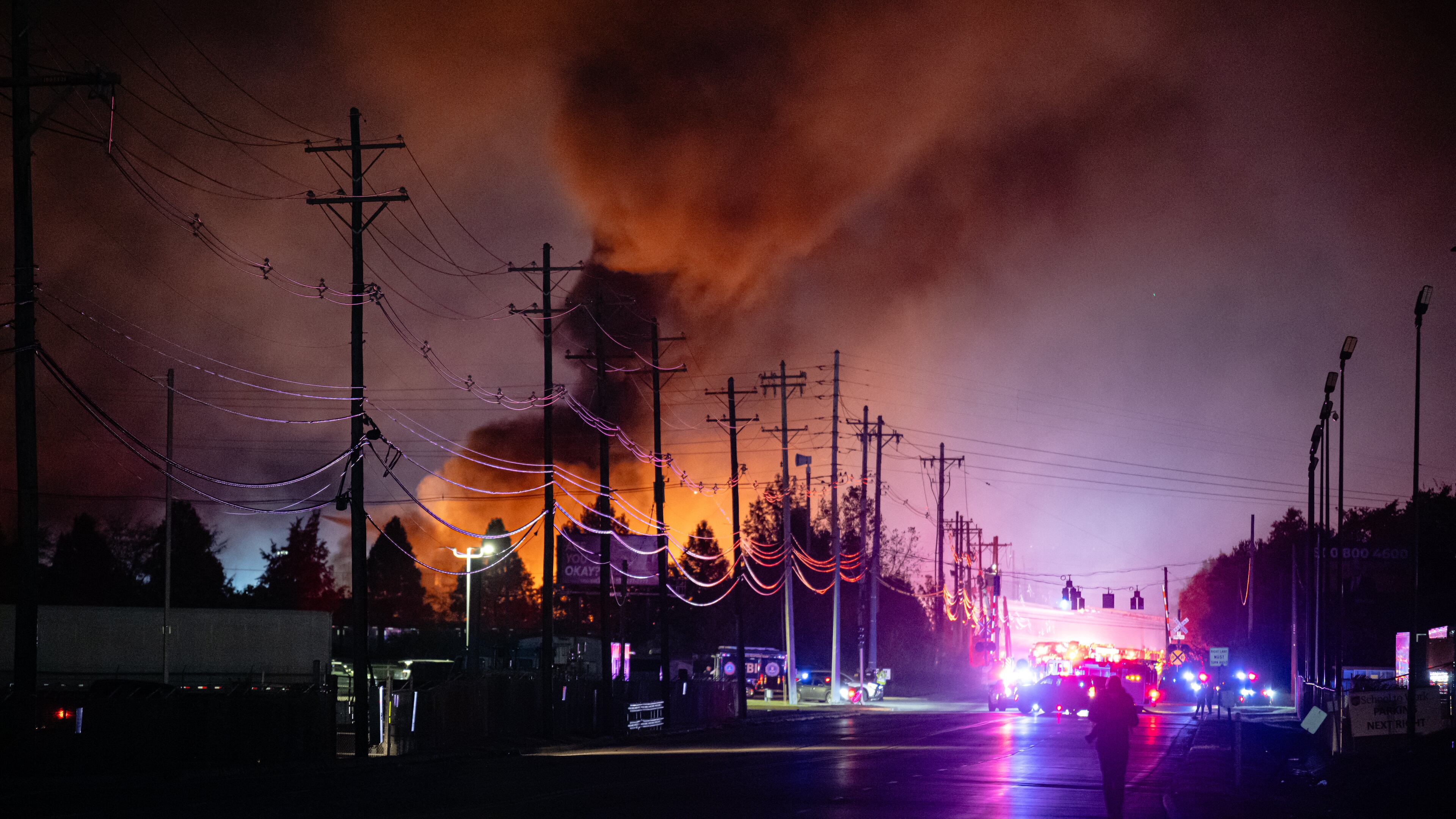 Plumes of smoke rise from the area of a UPS cargo plane crash at Louisville Muhammad Ali International Airport, on Tuesday, Nov. 4, 2025, in Louisville, Ky. (AP Photo/Jon Cherry)