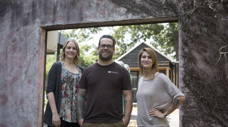 Kara Hidinger (from left), Ryan Smith and Jen Hidinger are seen at the entrance of the Staplehouse restaurant on Edgewood Avenue in Atlanta. (Phil Skinner)