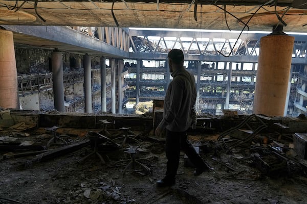 A man walks in the damaged headquarters of Islamic Republic of Iran Broadcasting, Iranian state television, in Tehran, Iran, Thursday, June 19, 2025. (AP Photo/Vahid Salemi)