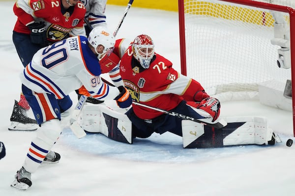 Edmonton Oilers' Corey Perry (90) is stopped by Florida Panthers goalie Sergei Bobrovsky (72) during the third period in Game 4 of the NHL hockey Stanley Cup Final in Sunrise, Fla., Thursday, June 12, 2025. (Nathan Denette/The Canadian Press via AP)