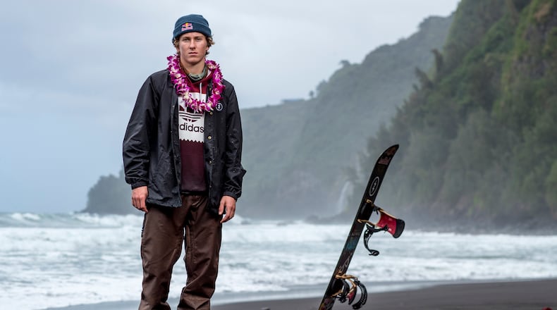 In this Feb. 21, 2017, photo provided by Red Bull, Lyon Farrell poses on a beach in Waipo Valley on the island of Hawaii. Farrell grew up skateboarding and surfing in Hawaii before a visit to New Zealand introduced him to snowboarding. Ever since, he's preferred landing triple corks to hanging 10 as he sets his sights on making the U.S. slopestyle squad for the Olympics next winter in South Korea.  (Zak Noyle/Red Bull via AP)