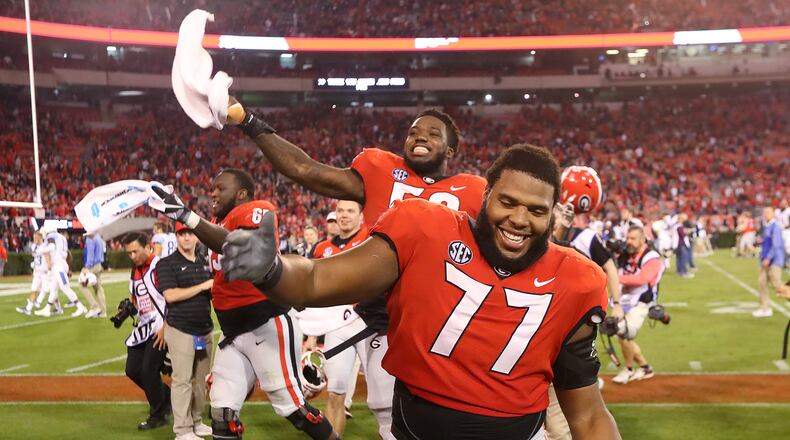 November 18, 2017 Athens: Georgia senior offensive lineman Isaiah Wynn and the Bulldogs celebrate a 42-13 vicotry over Kentucky in a NCAA college football game on Saturday, November 18, 2017, in Athens. Curtis Compton/ccompton@ajc.com