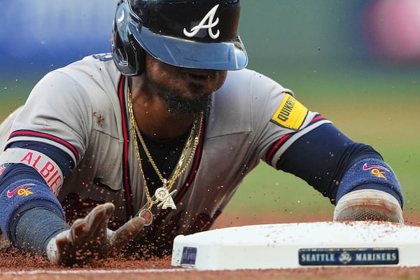 No photos of Jim Jarvis available ... so how about a little “Ozzie Albies sliding into third base” as a treat? (Lindsey Wasson/AP)