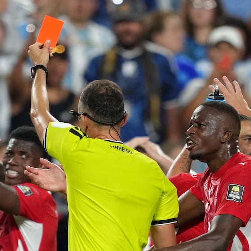 Referee Joao Pinheiro, of Portugal, gives a red card to Switzerland's Breel Embolo (7), left, during the World Cup quarterfinal soccer match between Argentina and Switzerland in Kansas City, Mo., Saturday, July 11, 2026. (AP Photo/Ed Zurga)