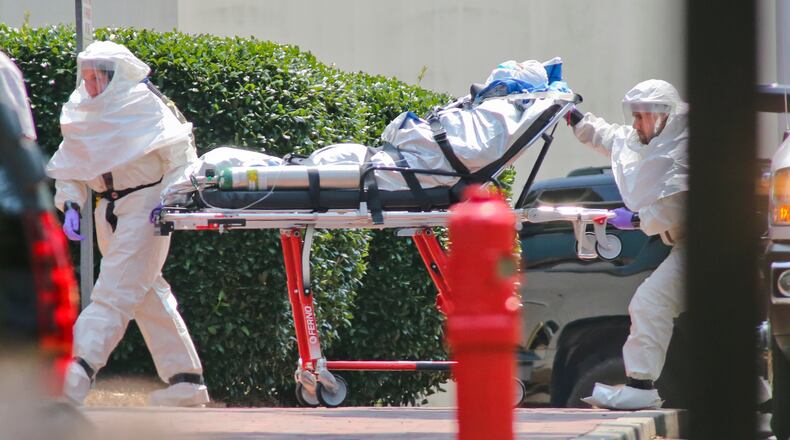 Medical workers roll patient Nancy Writebol into Emory Hospital. The second American aid worker infected with Ebola arrived Tuesday, Aug. 5, 2014 in Atlanta. Nancy Writebol arrived in a chartered jet at Dobbins Air Reserve Base and was then taken in an ambulance to Emory University Hospital. She was taken from the ambulance by gurney and rolled into the hospital by suited medical personnel. Three days earlier, Dr. Kent Brantly, also diagnosed with the virus, arrived at Emory walked from the ambulance. The two patients are being treated in an isolation unit. MANDATORY CREDIT / JOHN SPINK/JSPINK@AJC.COM