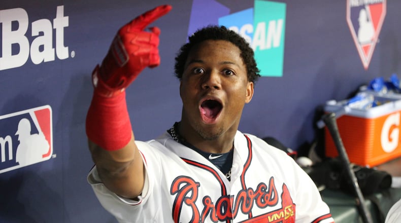 Atlanta Braves left fielder Ronald Acuna celebrates after hitting a grand slam home run in the dugout in the second inning against the Los Angeles Dodgers in Game 3 of a National League Division Series baseball game Sunday, October 7, 2018, in Atlanta. Curtis Compton/ccompton@ajc.com