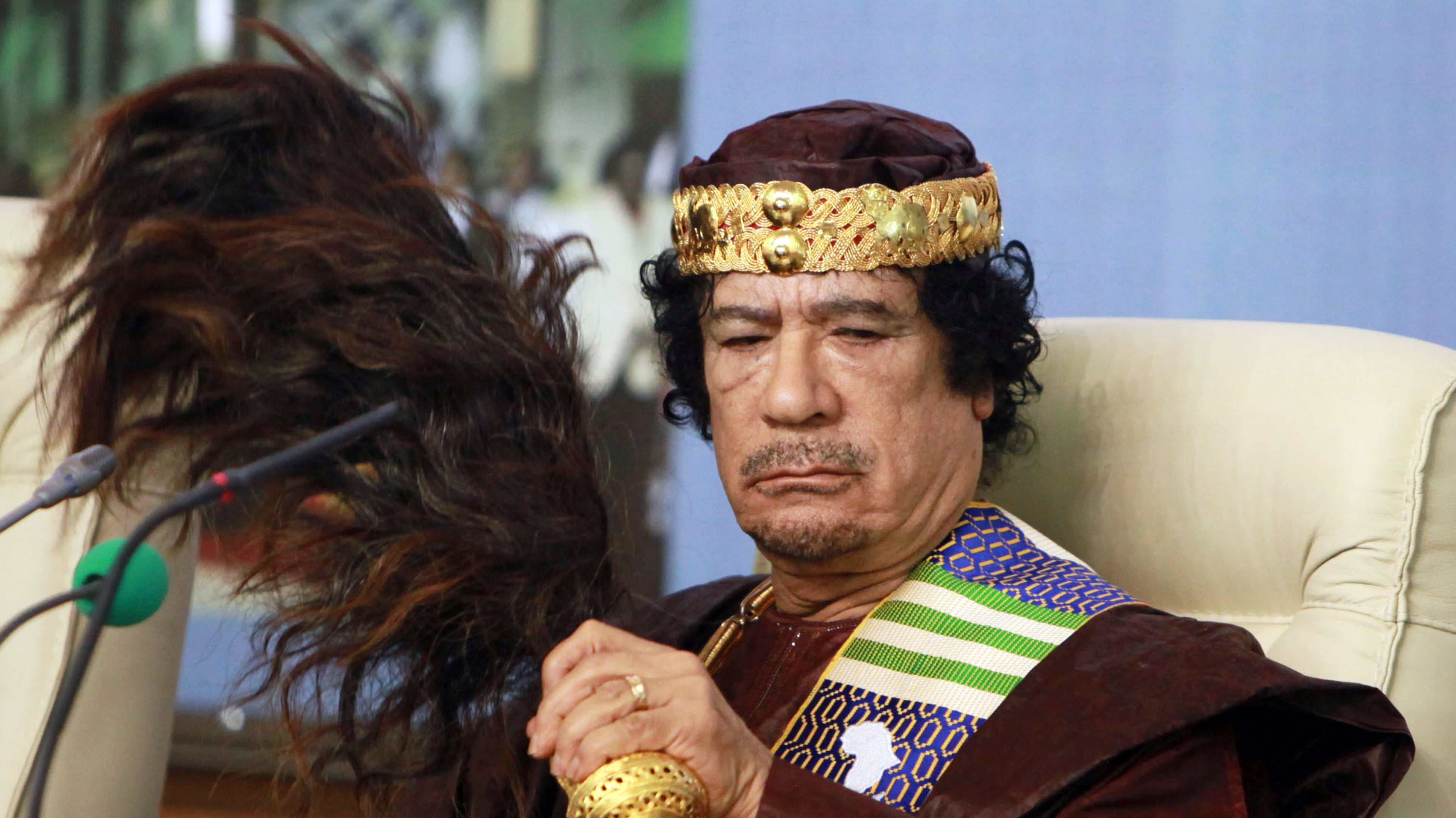 FILE - Libyan leader Moammar Gadhafi fans his face during the Forum of Kings, Princes, Sultans, Sheikhs and Mayors of Africa in Tripoli on Sept. 8 2010. (AP Photo/Abdel Magid Al Fergany, File)