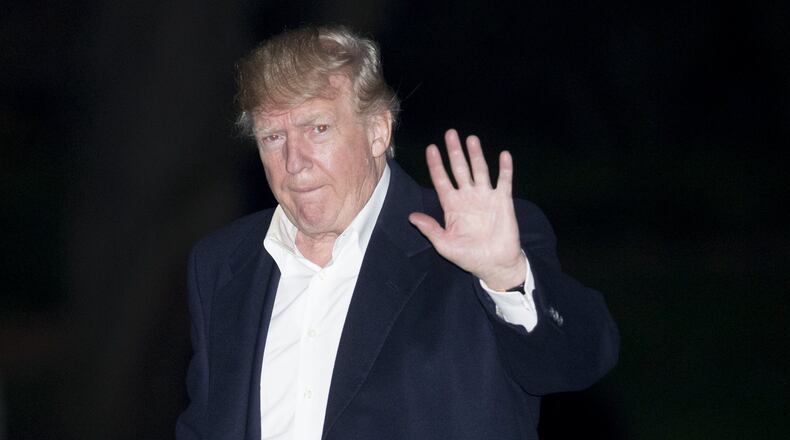 President Donald Trump walks on the South Lawn of the White House after returning from an 11-day Asia trip Nov. 14. Photo by Andrew Harrer-Pool/Getty Images)
