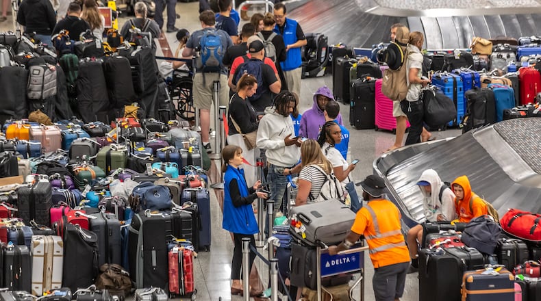 Baggage stored in the Delta’s baggage claim area wait for passengers to claim them. Long lines and baggage stockpiles returned Tuesday, July 23, 2024 as Hartsfield-Jackson International Airport’s new normal. Travelers have been sleeping at the Atlanta airport since the meltdown began Friday with a technology outage that affected Microsoft users around the world. (John Spink/AJC)