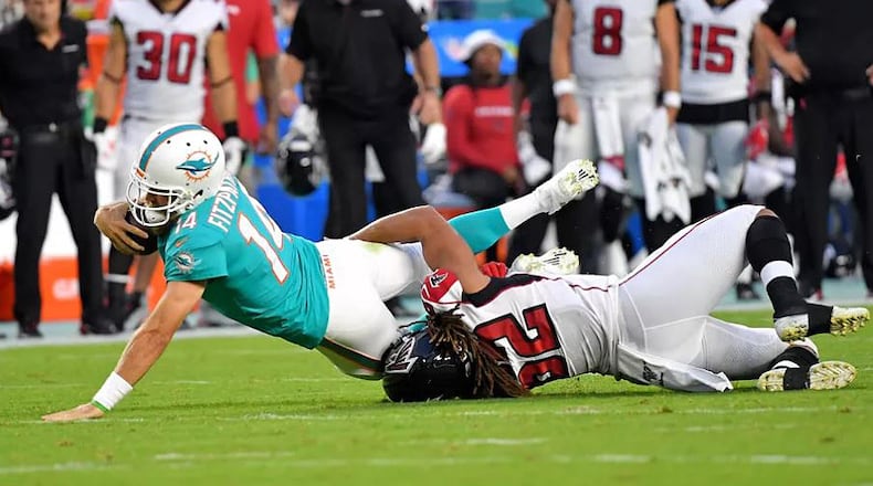 Falcons defender Austin Larkin takes down Dolphins QB Ryan Fitzpatrick during Thursday's preseason game. (Steve Mitchell-USA TODAY Sports)