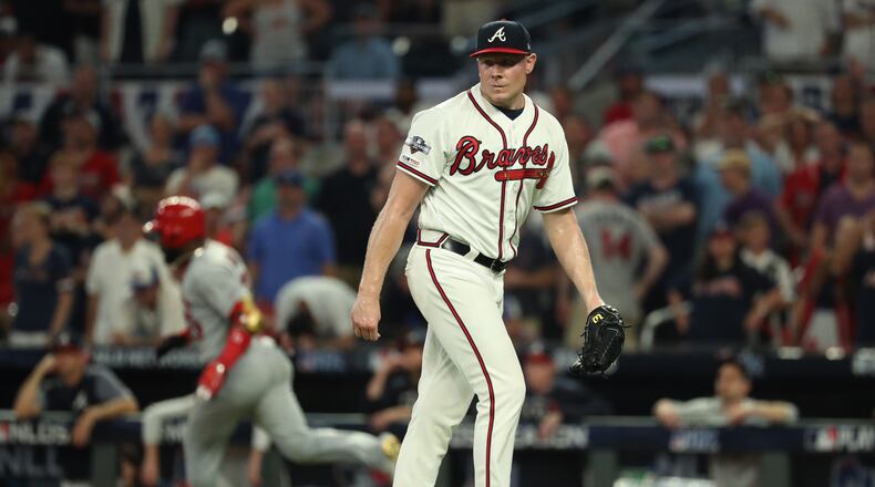 Braves relief pitcher Mark Melancon reacts after giving up a two-run double to the Cardinals’ Marcell Ozuna.