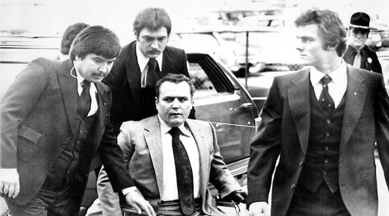 Hustler magazine publisher Larry Flynt is surrounded by heavy security as he arrives March 19, 1979, at the Fulton County Courthouse for the start of his trial on obscenity charges. In June 1984, Joseph Paul Franklin, a self-avowed white supremacist, was indicted by a Gwinnett County grand jury and charged with aggravated assault in the 1978 shootings of Larry Flynt (above) and Gene Reeves (not pictured). Flynt was left paralyzed from the waist down by the attack; Reeves recovered and went on to become a judge in Gwinnett County. Franklin, a serial killer who may have killed up to 22 people, was executed by lethal injection in Missouri in November 2013. Reeves died in July 2015 at age 85.