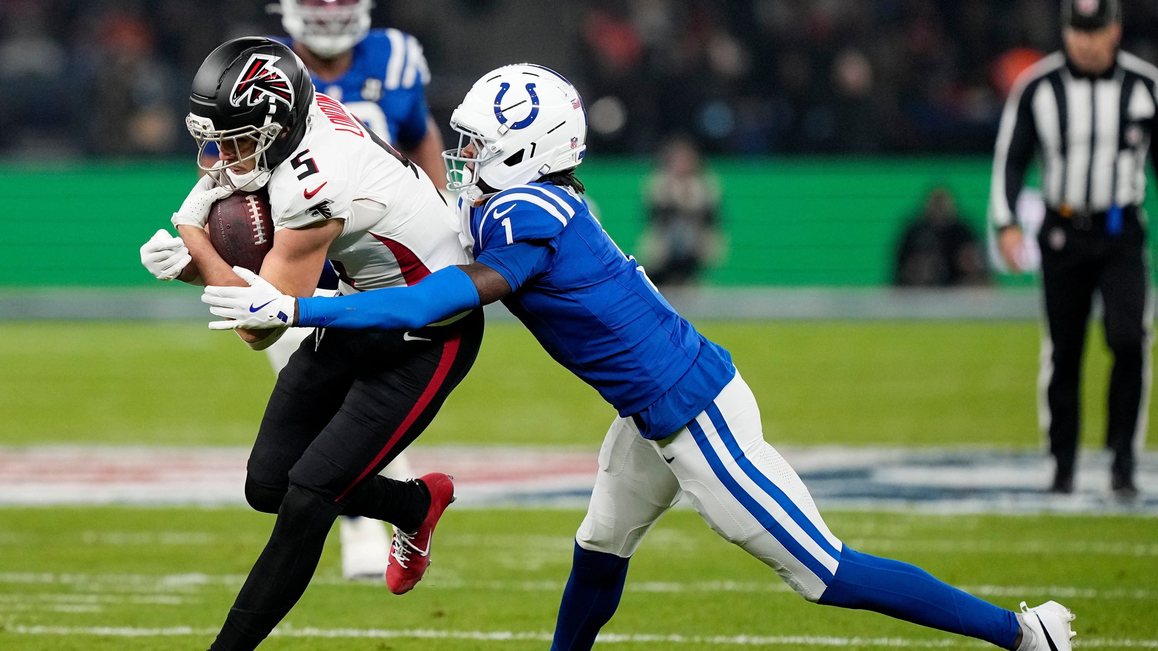 Atlanta Falcons wide receiver Drake London (5) is tackled by Indianapolis Colts cornerback Sauce Gardner (1) after catching a pass during the first half of an NFL football game, Sunday, Nov. 9, 2025, in Berlin, Germany. (AP Photo/Martin Meissner)