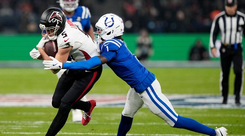Atlanta Falcons wide receiver Drake London (5) is tackled by Indianapolis Colts cornerback Sauce Gardner (1) after catching a pass during the first half of an NFL football game, Sunday, Nov. 9, 2025, in Berlin, Germany. (AP Photo/Martin Meissner)