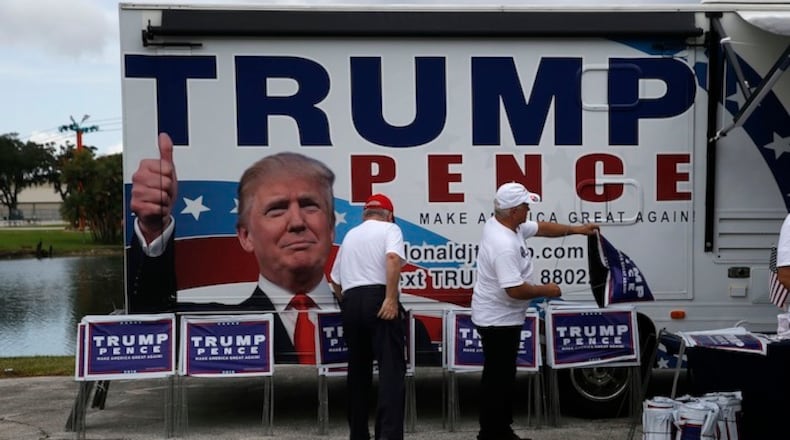 Campaign volunteers ready signs before Republican presidential candidate Donald Trump speaks at a campaign rally in Tampa, Wednesday, Aug. 24, 2016. (AP Photo/Gerald Herbert)