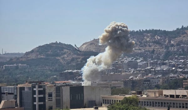 In this photo released by the Syrian official news agency SANA, smoke rises from an Israeli airstrike that hit the Syrian Defense Ministry in Damascus, Syria, Wednesday, July 16, 2025. (SANA via AP)