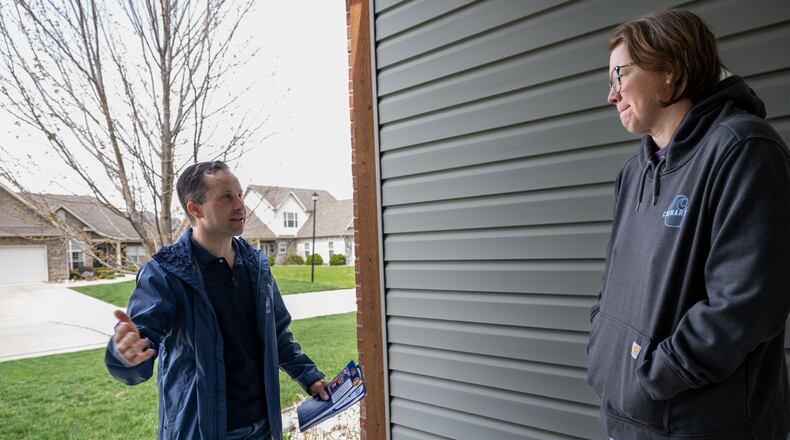 Julie Wise, 48, speaks with Indiana state Sen. Spencer Deery, R-West Lafayette, who represents District 23, as he canvasses a neighborhood, Saturday, April 11, 2026, in West Lafayette, Ind. (AP Photo/Doug McSchooler)
