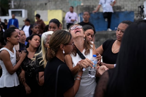 Family and friends grieve during the burial service for Marilenny Pilarte who died at the Jet Set nightclub when its roof collapsed, in Haina, Dominican Republic, Thursday, April 10, 2025. (AP Photo/Matias Delacroix)