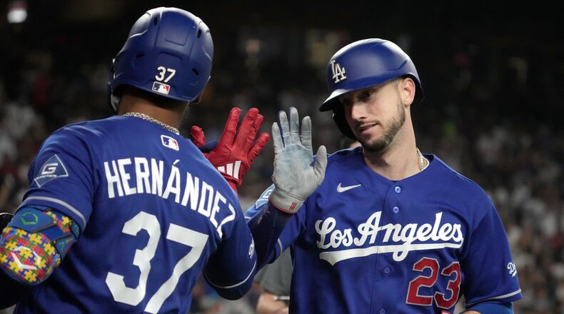 Los Angeles Dodgers' Kyle Tucker celebrates with Teoscar Hernández (37) after hitting a solo home run against the Arizona Diamondbacks in the eighth inning of a baseball game, Saturday, Aug. 8, 2026, in Phoenix. (AP Photo/Rick Scuteri)