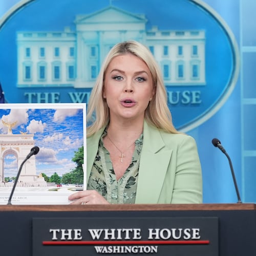 White House press secretary Karoline Leavitt holds up an artist rendering of the new triumphal arch as she speaks with reporters in the James Brady Press Briefing Room at the White House, Wednesday, April 15, 2026, in Washington. (AP Photo/Alex Brandon)