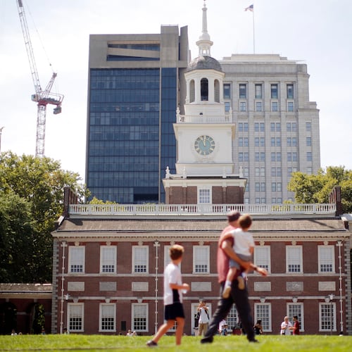 FILE- People move past Independence Hall at the Independence National Historical Park in Philadelphia, Aug. 25, 2016. (AP Photo/Matt Rourke, File)