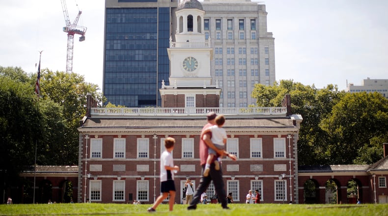 FILE- People move past Independence Hall at the Independence National Historical Park in Philadelphia, Aug. 25, 2016. (AP Photo/Matt Rourke, File)