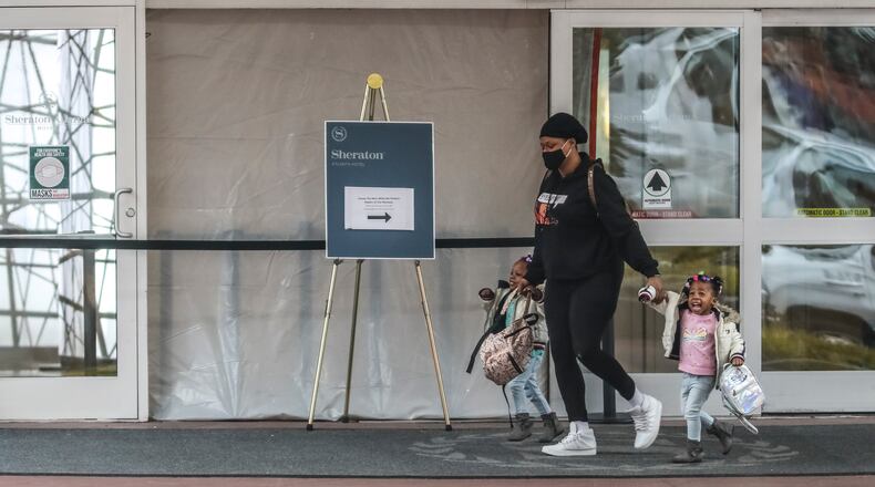 February 4, 2021 Atlanta: Hotel guests walk across the damaged front entrance of the Sheraton Hotel where it was blocked off Thursday, Feb. 4, 2021 in downtown Atlanta. Atlanta police officers are investigating a hit-and-run crash that happened Wednesday night where they were surprised to find the suspect and his sedan only made it as far as the hotel lobby. Houston Garner, 32, of Canton, is accused of backing into the glass entry doors of the Sheraton Atlanta and driving his car through the lobby to get away from the pursuing officers, according to Atlanta police. He was eventually apprehended on an upper floor of the hotel, police spokesman Officer Steve Avery said. Police were called to the Courtland Street hotel about 11 p.m. after a woman said a black car hit her vehicle in the parking lot and drove off. She sustained minor injuries but was not taken to a hospital, Avery said. ÒWhile officers were still on scene a security guard at the hotel advised officers that the hit-and-run vehicle, a black Volkswagen Passat, had just backed into the hotel doors causing damage,Ó the spokesman said in a statement. When the officers tried to speak with the man, later identified as Garner, he took off again, Avery said. ÒThe driver refused to comply and drove away, eventually driving through the entrance and into the lobby of the hotel,Ó he said. Garner was arrested on charges of hit-and-run, reckless driving, failure to maintain lane, criminal damage to property and obstruction. He was taken to the Fulton County Jail for the second time in a month. Garner was just released from custody Friday after posting an $8,000 surety bond. He faces charges of theft by receiving stolen property, drug and weapon possession, and driving on a suspended or revoked license stemming from a Jan. 23 arrest in Sandy Springs, jail records show. Bond has not been determined on his most recent charges. (John Spink / John.Spink@ajc.com)