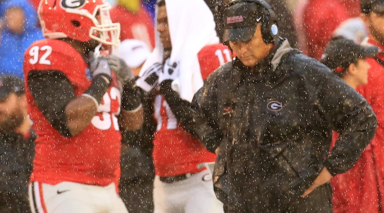 Georgia head coach Mark Richt walks the sidelines in a downpour during the second half of a 38-10 loss to Alabama in their football game on Saturday, Oct. 3, 2015, in Athens. (Curtis Compton/ccompton@ajc.com)