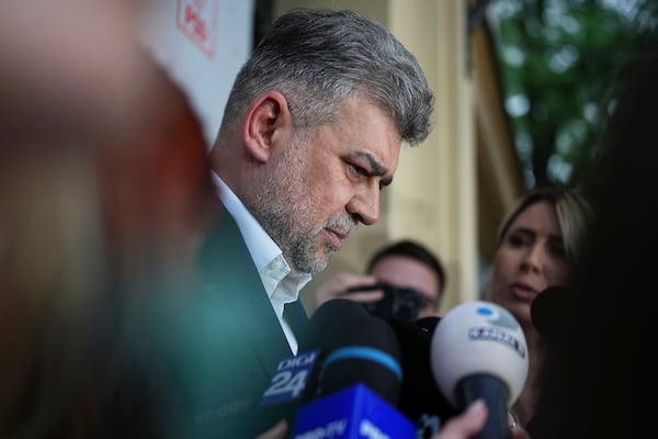 Romanian Prime Minister Marcel Ciolacu is surrounded by media at the PSD headquarters as he announces his resignation, in Bucharest, Romania, Monday, May 5, 2025, the day after the governing coalition's candidate failed to advance to the runoff in the presidential election rerun. (AP Photo/Andreea Alexandru)