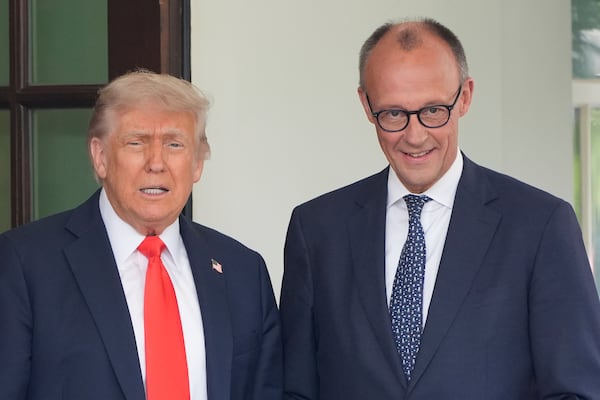 President Donald Trump, left, greets Germany's Chancellor Friedrich Merz upon his arrival at the White House, Thursday, June 5, 2025, in Washington. (AP Photo/Alex Brandon)