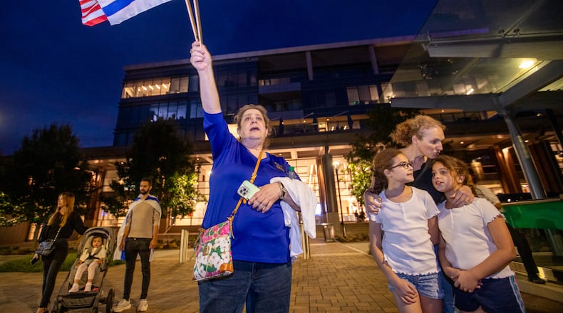Thousands of Israel supporters, including Rachel Domba, left, and Shiri Tzuk, right, with her children Naama Tzuk and Nora Tzuk, gather inside and outside of City Springs in Sandy Springs on Tuesday, Oct 10, 2023 for a rally for Israel. (Jenni Girtman for The Atlanta Journal-Constitution)