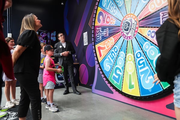 Children watch the wheel spin at Great Big Game Show in The Battery in Atlanta on Saturday, May 8, 2026. (Abbey Cutrer/AJC)